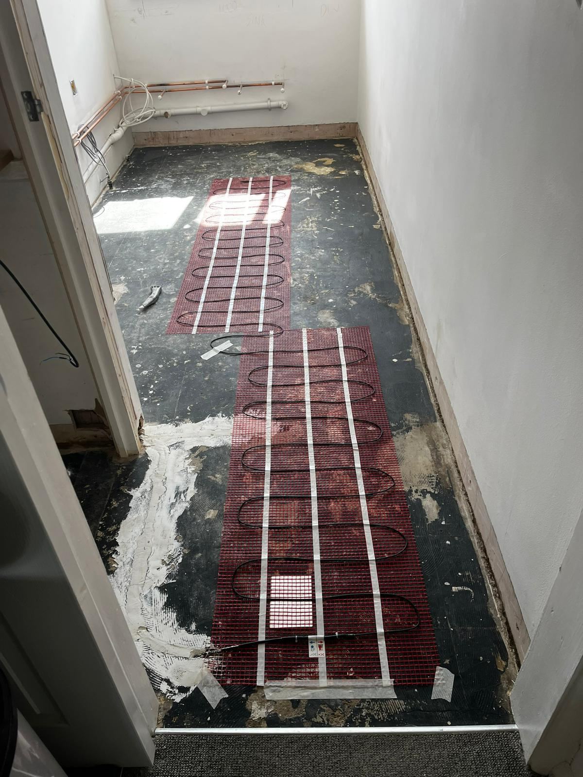 Electric underfloor heating mats laid before tiling